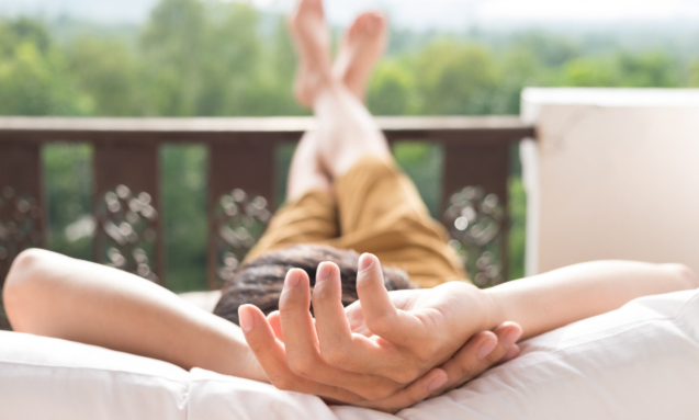 Young man relax on bed and enjoying mountain view.